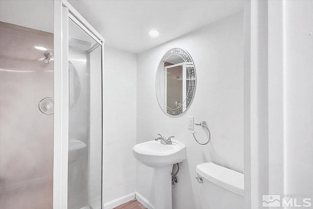 240 Bisby Street Reno, NV 89512 - Photo 17 of 27 a bathroom with a toilet sink and mirror