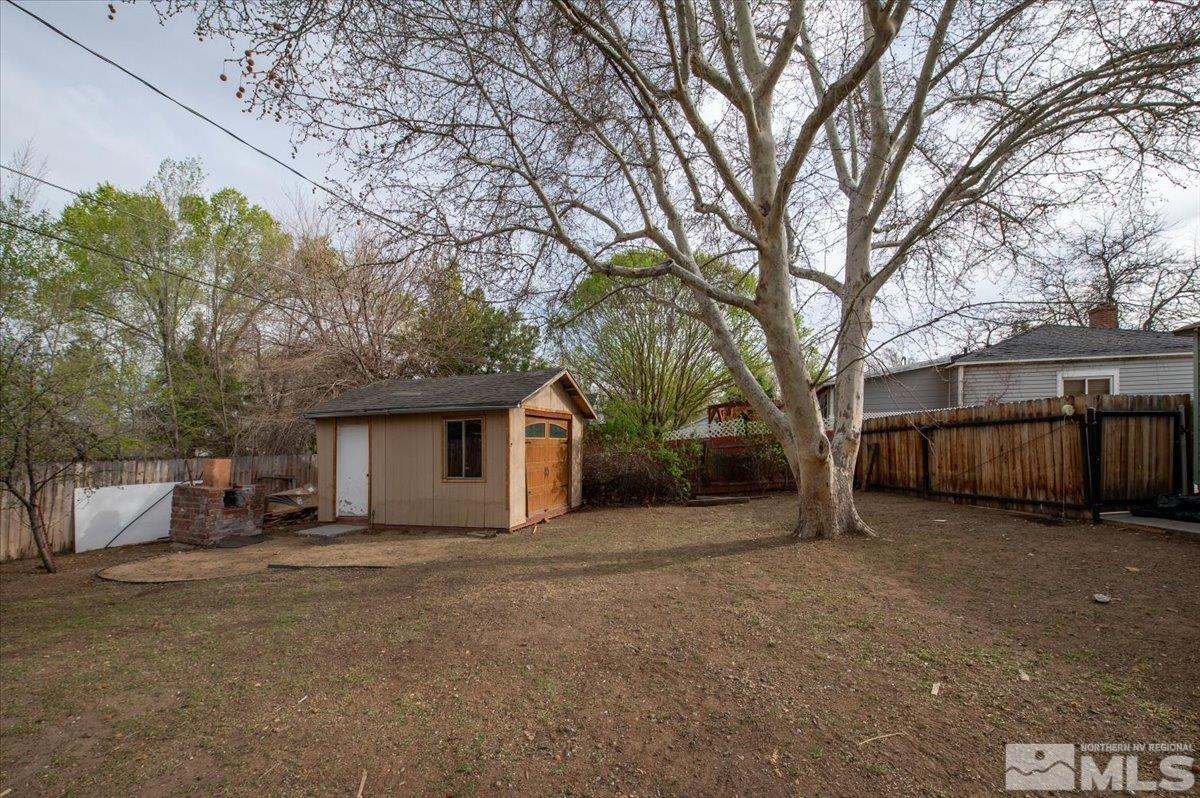 240 Bisby Street Reno, NV 89512 - Photo 21 of 27 a view of a house with a large tree in front of a house