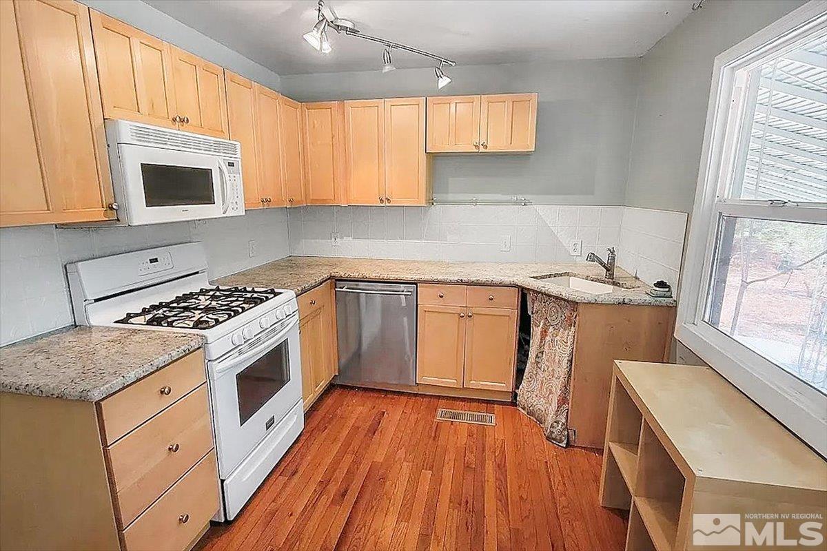 240 Bisby Street Reno, NV 89512 - Photo 4 of 27 a kitchen with a sink a stove and cabinets
