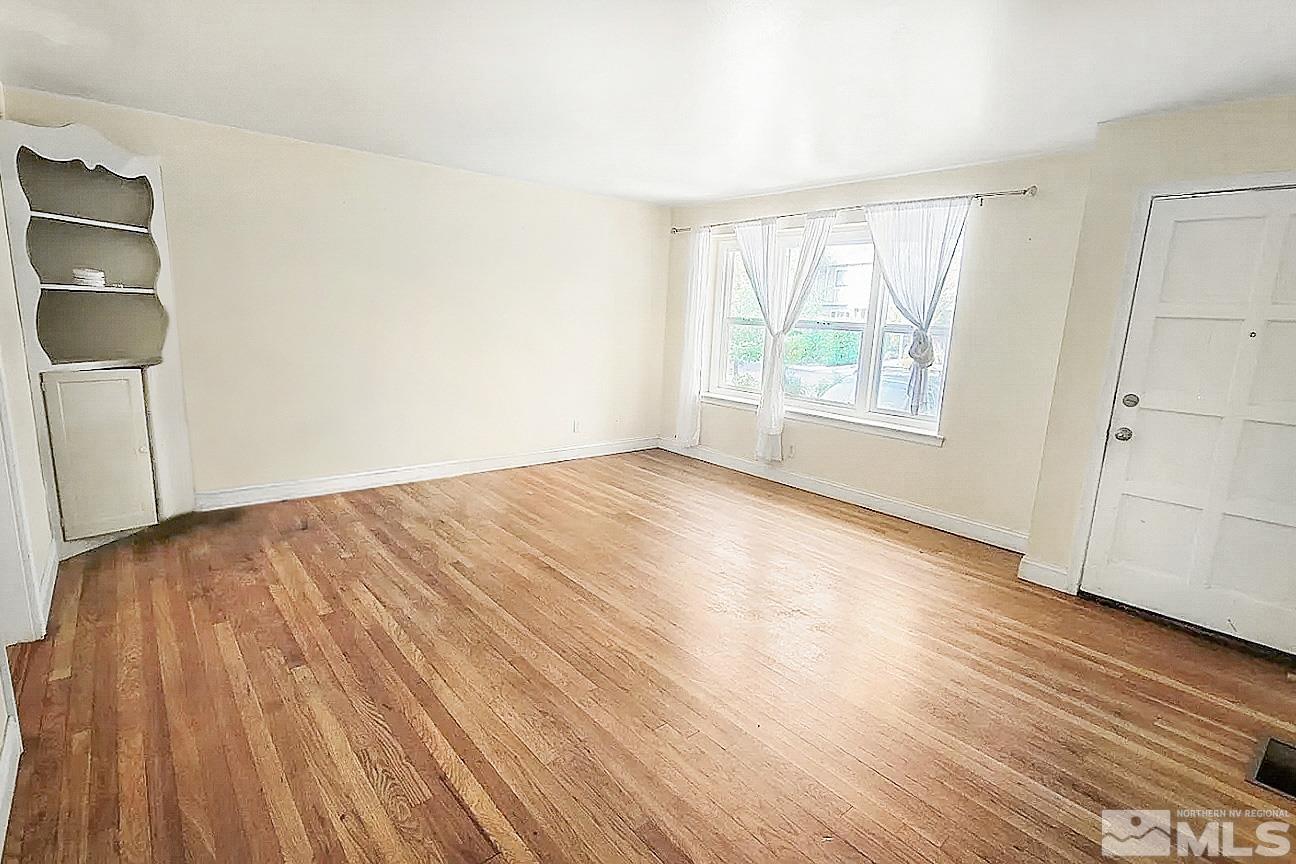 240 Bisby Street Reno, NV 89512 - Photo 6 of 27 an empty room with wooden floor and windows