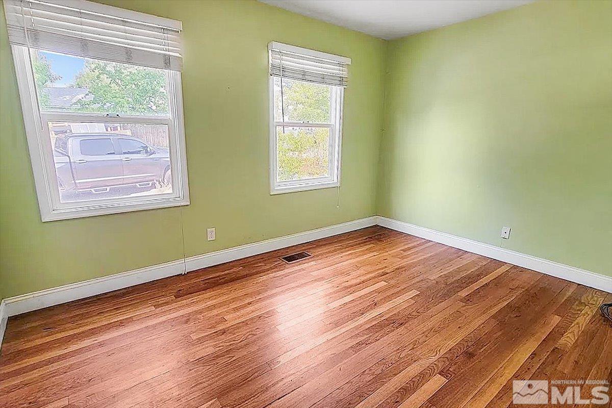 240 Bisby Street Reno, NV 89512 - Photo 7 of 27 an empty room with wooden floor and windows