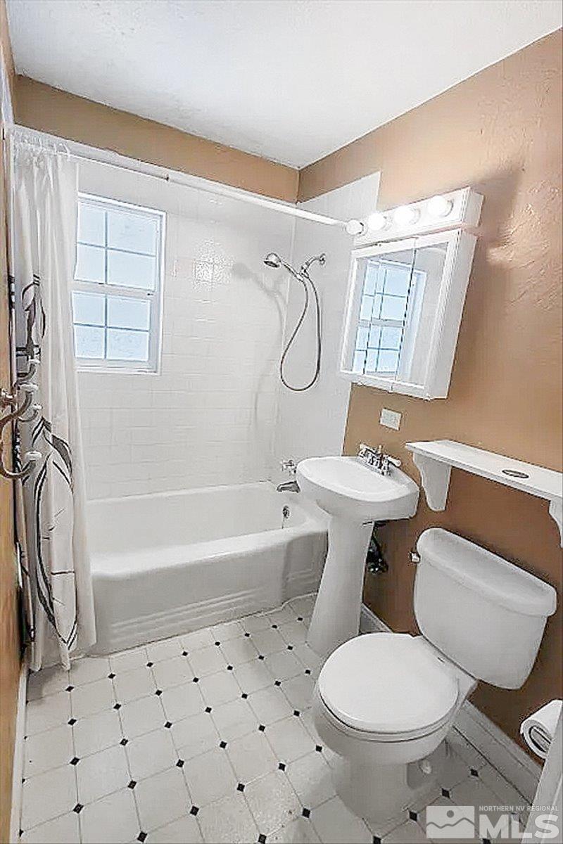 240 Bisby Street Reno, NV 89512 - Photo 9 of 27 a bathroom with a sink toilet and shower