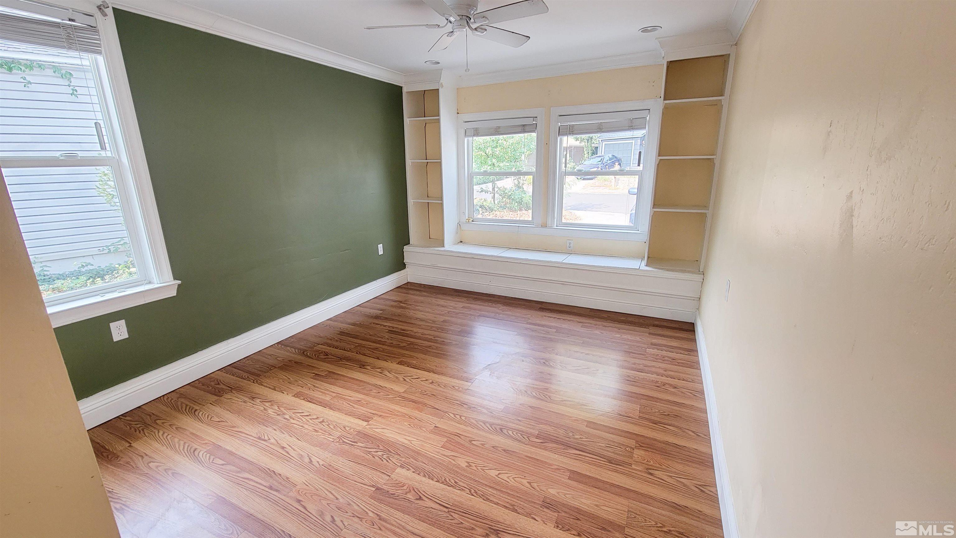 240 Bisby Street Reno, NV 89512 - Photo 10 of 27 a view of an empty room with wooden floor and a window