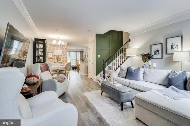 a living room with furniture and a chandelier
