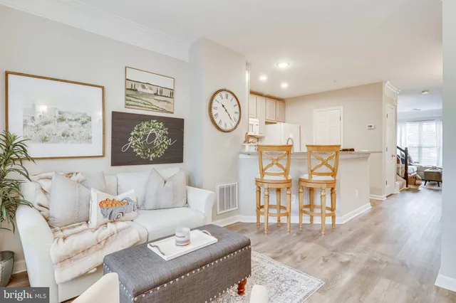 a living room with furniture and a clock