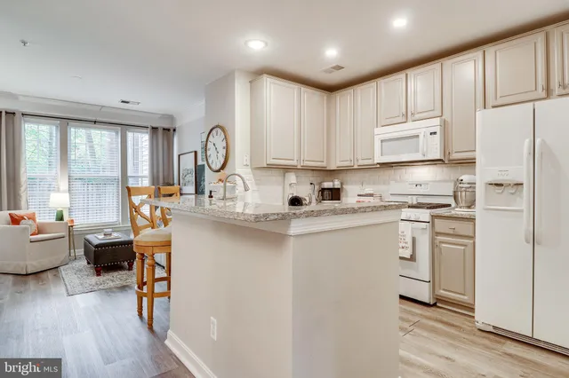 a kitchen with stainless steel appliances granite countertop a refrigerator sink and cabinets