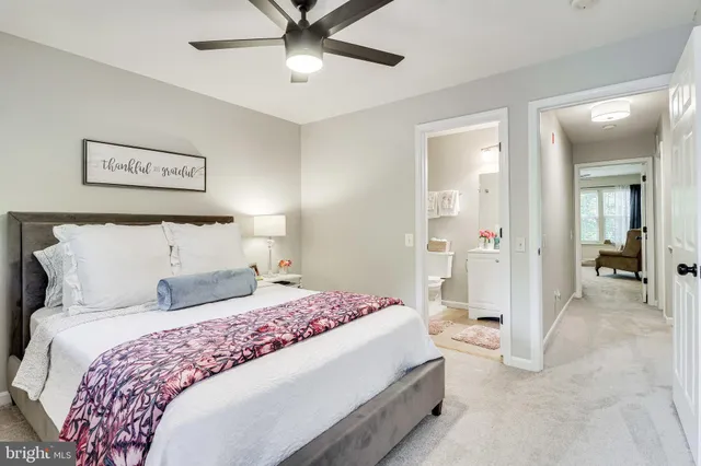 a bedroom with a bed and painting on the wall