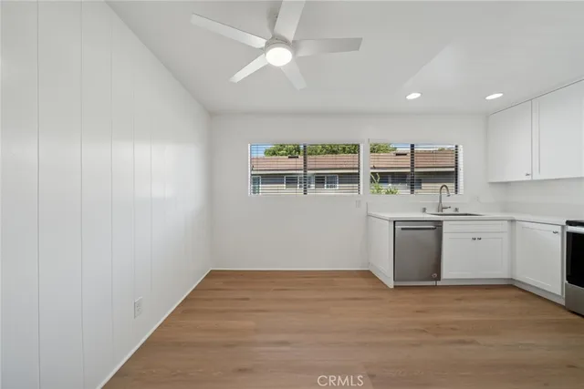 a view of a kitchen with wooden floor and a sink