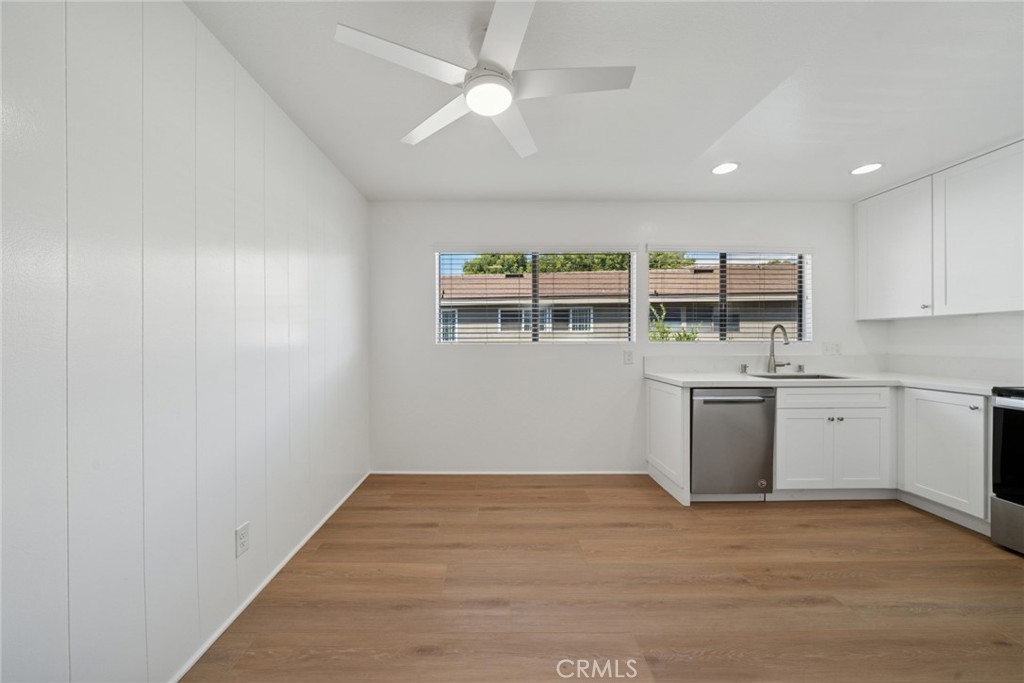 82 Streamwood Irvine, CA 92620 - Photo 11 of 26 a view of a kitchen with wooden floor and a sink