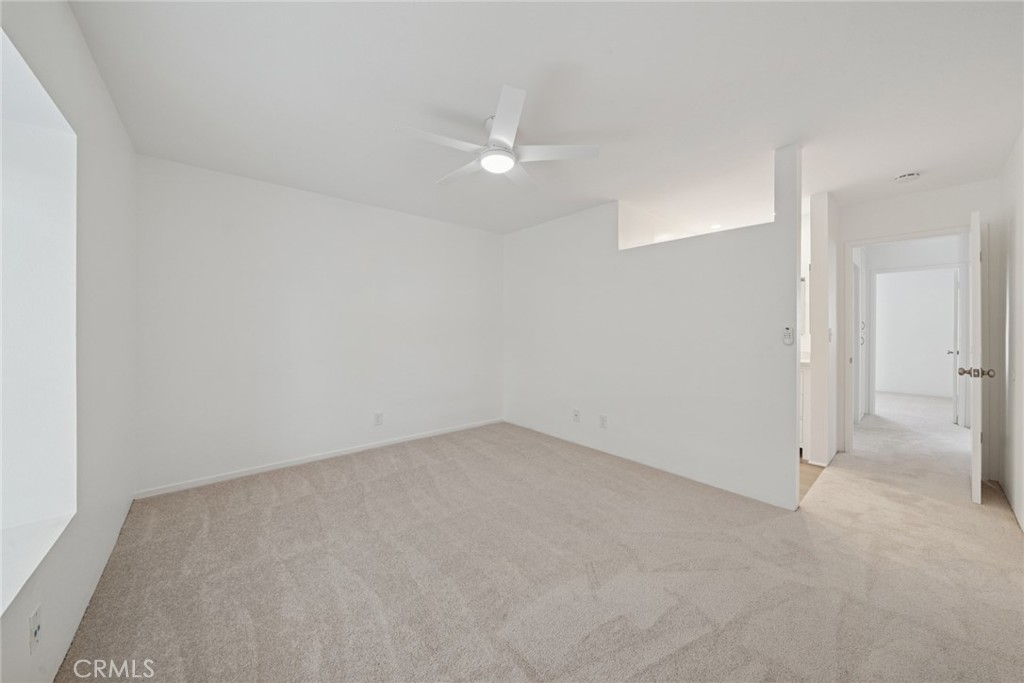 82 Streamwood Irvine, CA 92620 - Photo 12 of 26 an empty room with a ceiling fan and bathroom