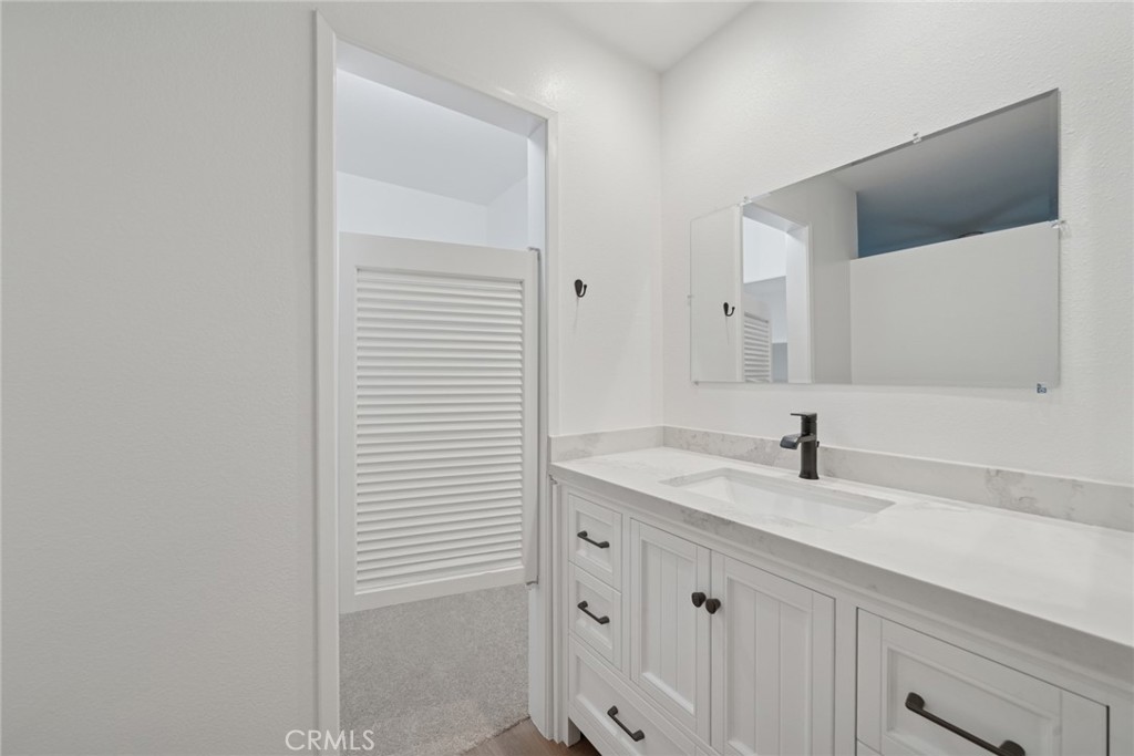 82 Streamwood Irvine, CA 92620 - Photo 14 of 26 a bathroom with a sink and a mirror