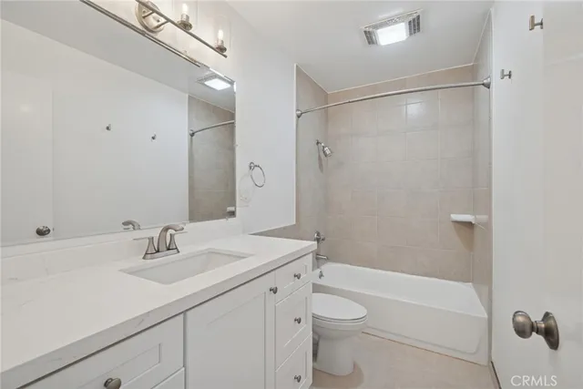 a bathroom with a sink a mirror toilet and bathtub