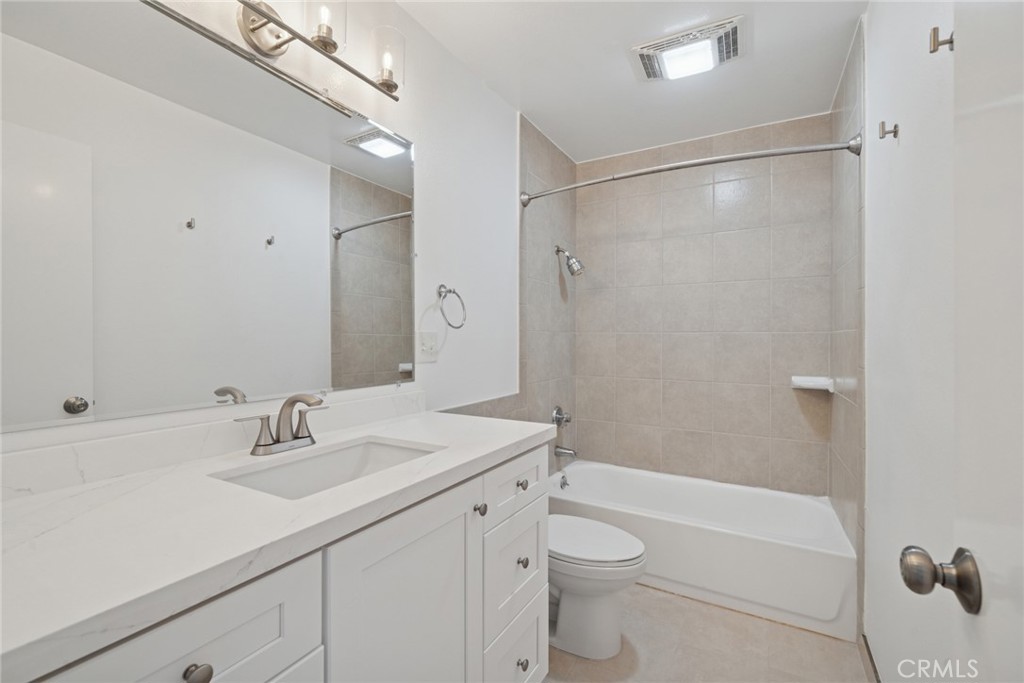 82 Streamwood Irvine, CA 92620 - Photo 15 of 26 a bathroom with a sink a mirror toilet and bathtub