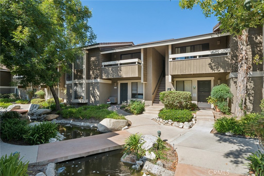 82 Streamwood Irvine, CA 92620 - Photo 20 of 26 a front view of a house with a yard