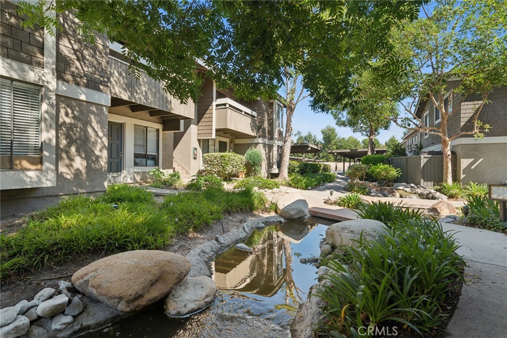 82 Streamwood Irvine, CA 92620 - Photo 21 of 26 a view of a chairs and table in backyard