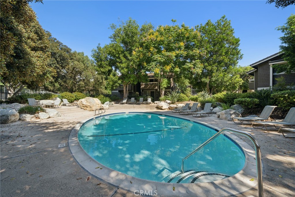 82 Streamwood Irvine, CA 92620 - Photo 24 of 26 a view of a swimming pool with a yard and plants