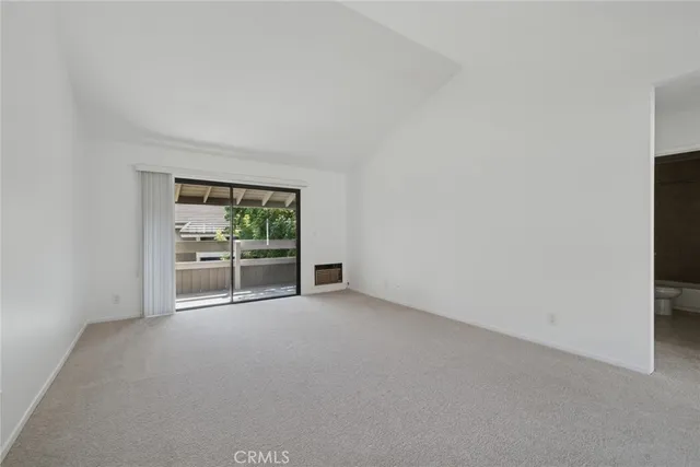 a view of an empty room with a fireplace
