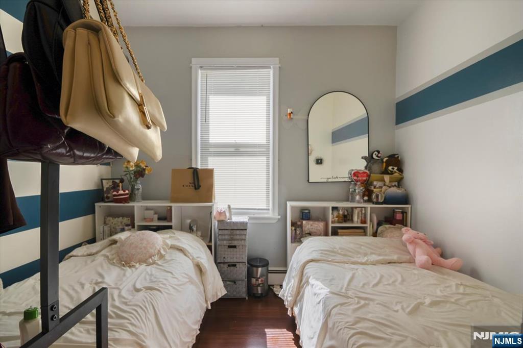 22 Tuttle Street Wallington, NJ 07057 - Photo 11 of 33 a bedroom with a bed and a chandelier