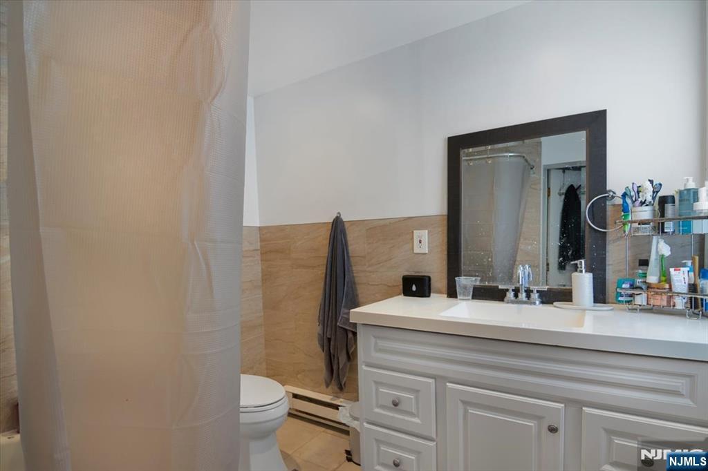 22 Tuttle Street Wallington, NJ 07057 - Photo 12 of 33 a bathroom with a sink and a mirror