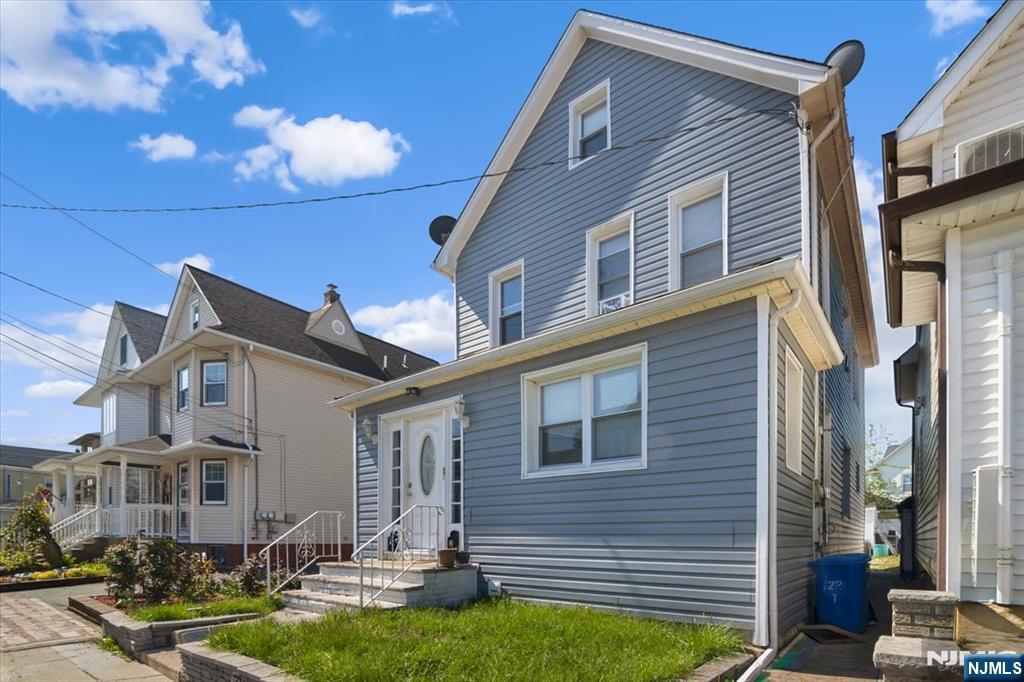 22 Tuttle Street Wallington, NJ 07057 - Photo 2 of 33 a front view of a house with swimming pool and chairs
