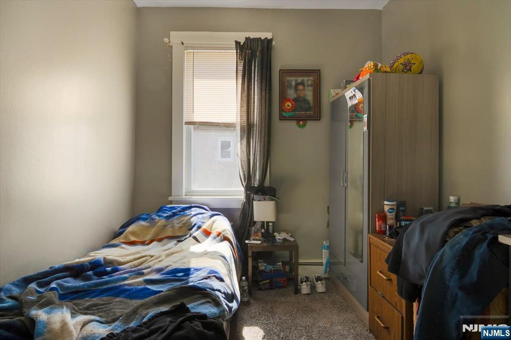 22 Tuttle Street Wallington, NJ 07057 - Photo 23 of 33 a bedroom with a bed and a window