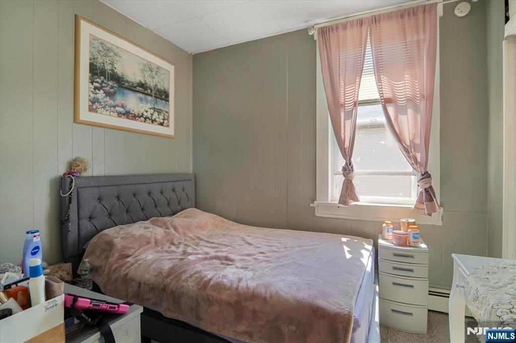 22 Tuttle Street Wallington, NJ 07057 - Photo 26 of 33 a bed sitting in a bedroom next to a window