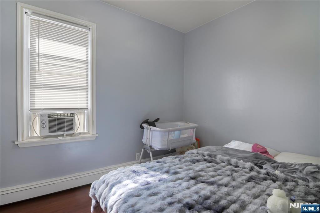22 Tuttle Street Wallington, NJ 07057 - Photo 6 of 33 a bedroom with a bed and a window