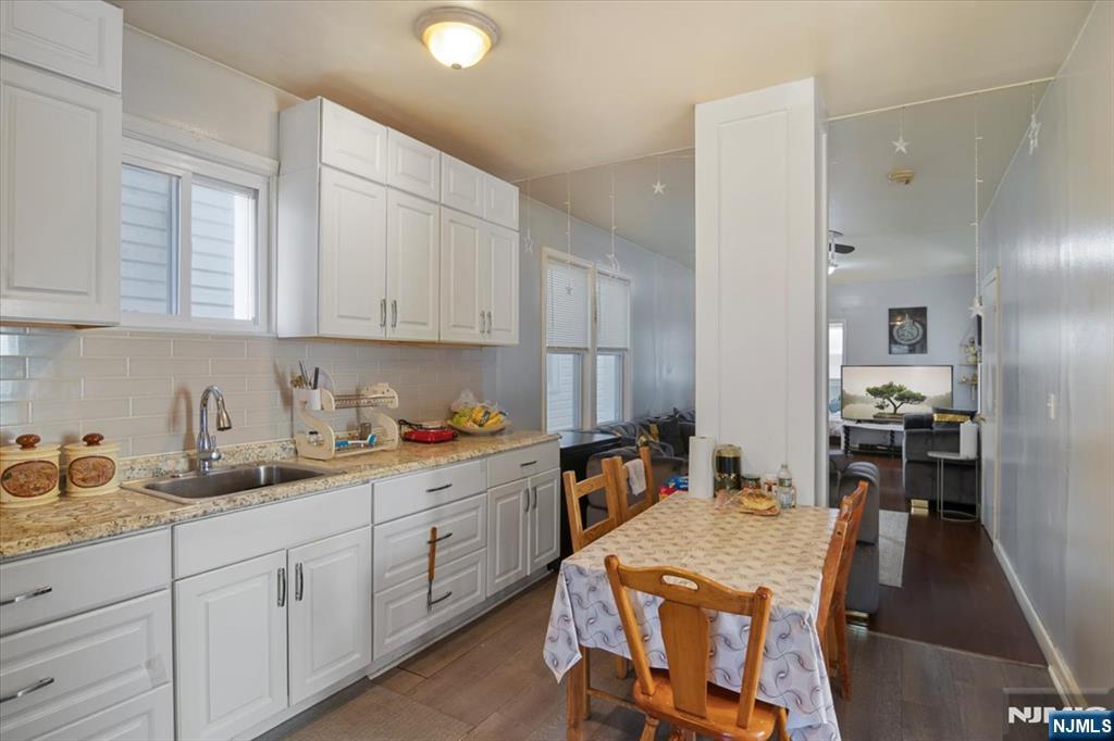 22 Tuttle Street Wallington, NJ 07057 - Photo 8 of 33 a kitchen that has a lot of cabinets a sink and appliances in it