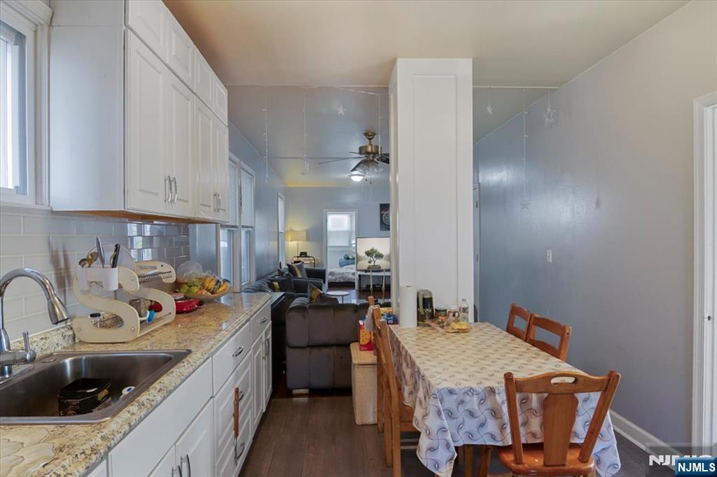 22 Tuttle Street Wallington, NJ 07057 - Photo 9 of 33 a kitchen that has a sink and chairs