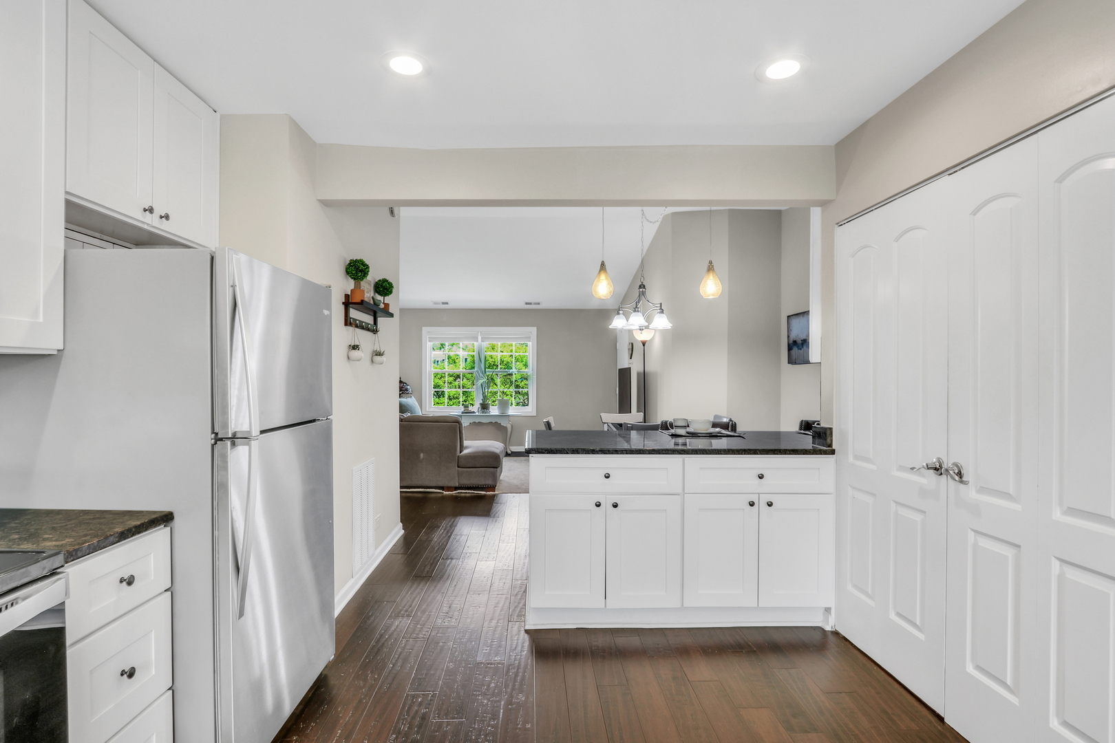 104 East Winchester Road, Unit E Libertyville, IL 60048 - Photo 11 of 23 a kitchen with white cabinets and refrigerator