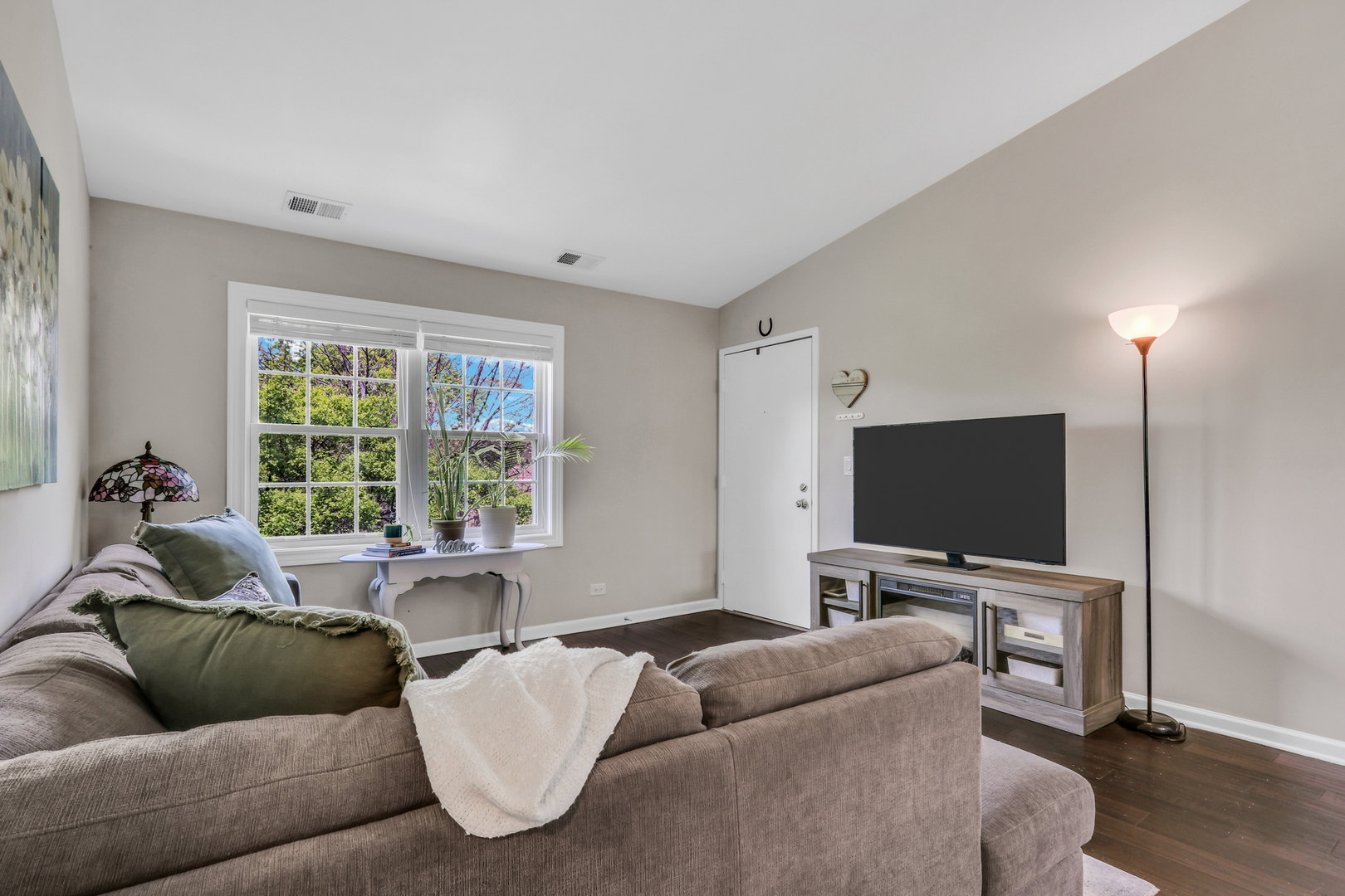 104 East Winchester Road, Unit E Libertyville, IL 60048 - Photo 3 of 23 a living room with furniture and a flat screen tv