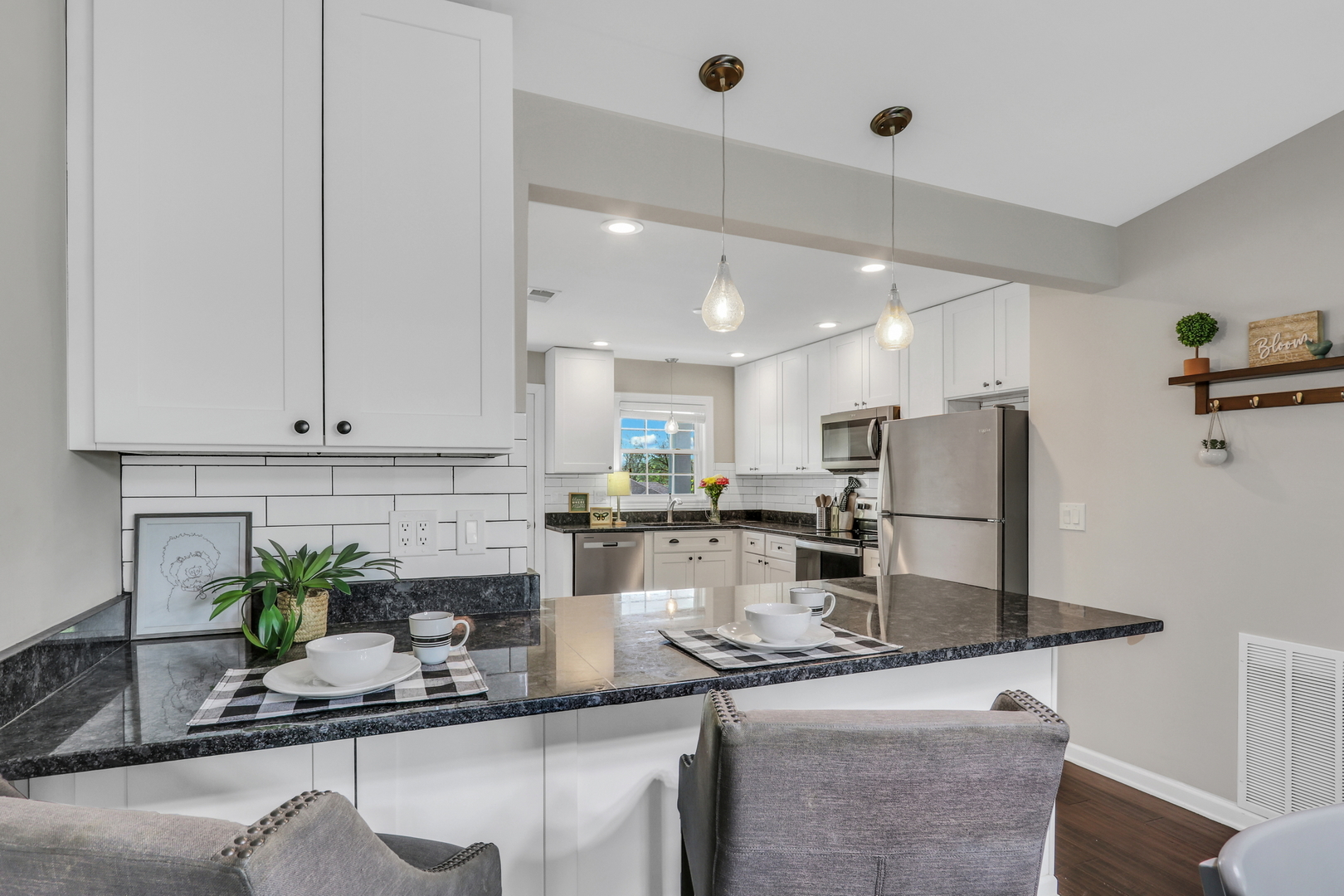 104 East Winchester Road, Unit E Libertyville, IL 60048 - Photo 7 of 23 a kitchen with kitchen island granite countertop a counter space cabinets stainless steel appliances and a counter top space