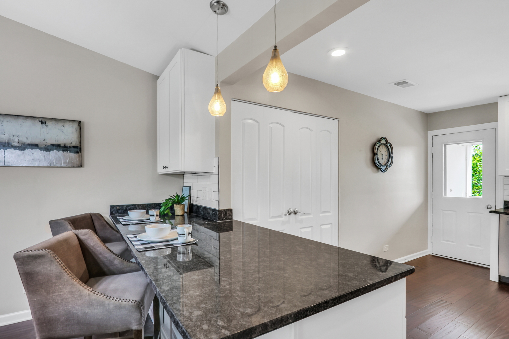 104 East Winchester Road, Unit E Libertyville, IL 60048 - Photo 8 of 23 a view of kitchen island with furniture and wooden floor