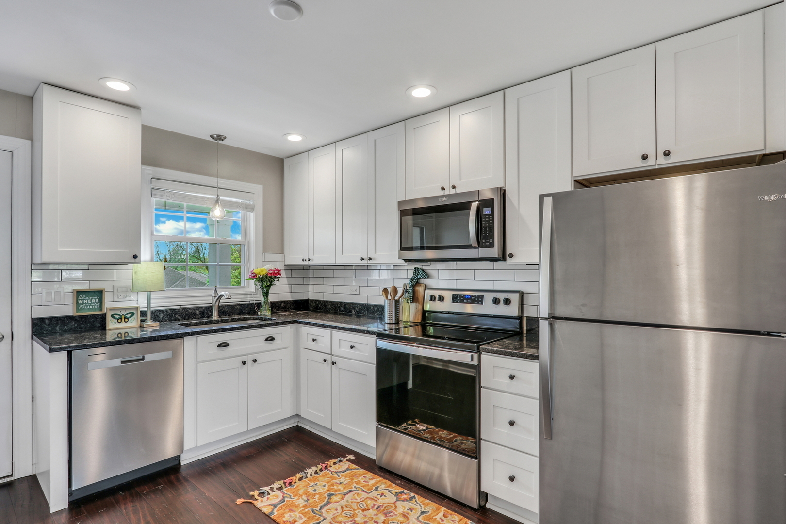 104 East Winchester Road, Unit E Libertyville, IL 60048 - Photo 10 of 23 a kitchen with white cabinets stainless steel appliances and a sink