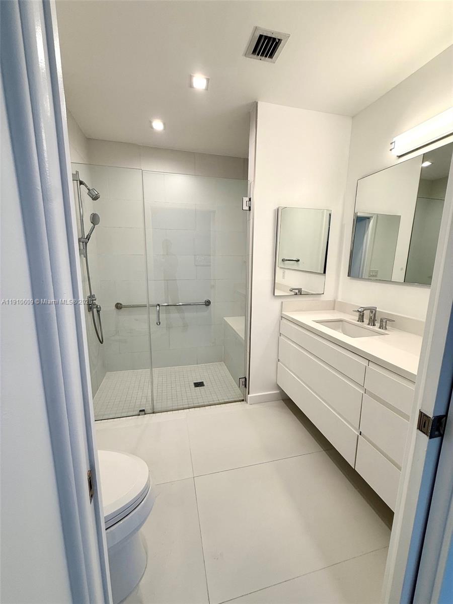 1241 Southwest 30th Place, Unit 1241 Miami, FL 33135 - Photo 8 of 10 a bathroom with a sink a toilet and shower