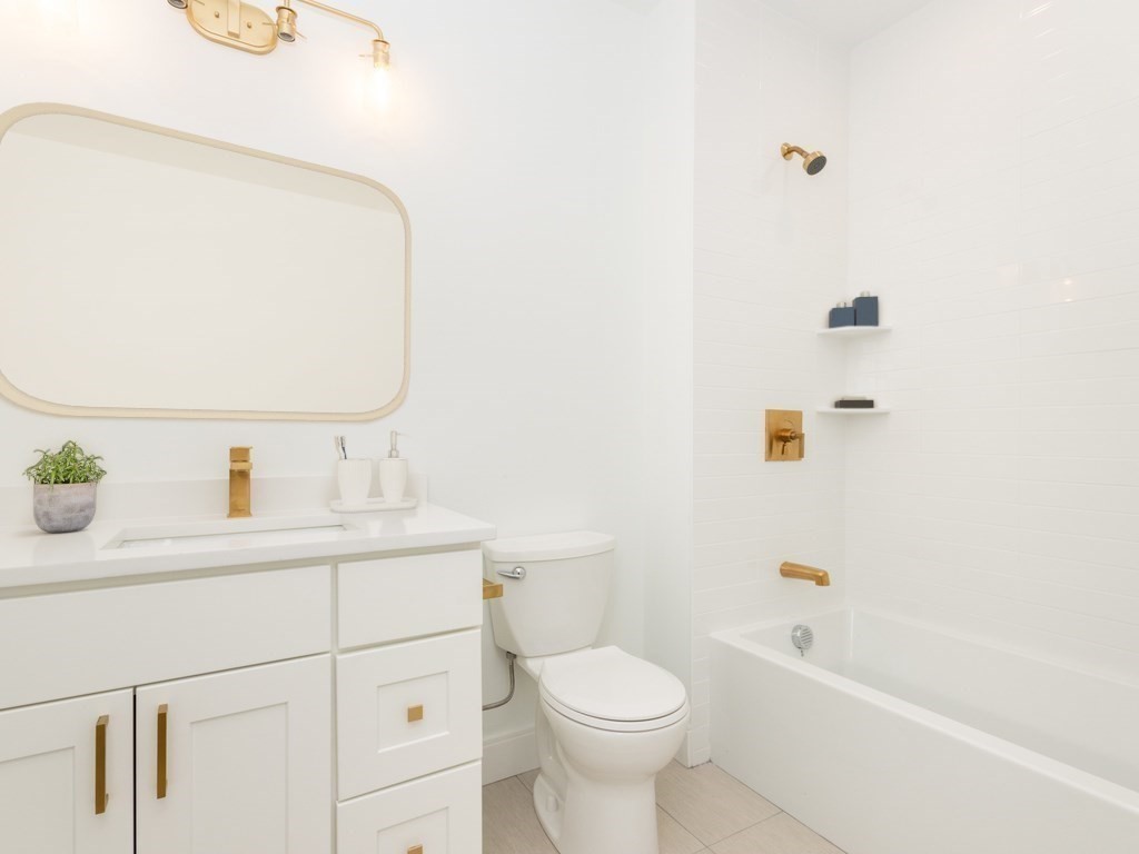 2 Neponset, Unit 3 Boston, MA 02122 - Photo 8 of 8 a bathroom with a sink a toilet and shower