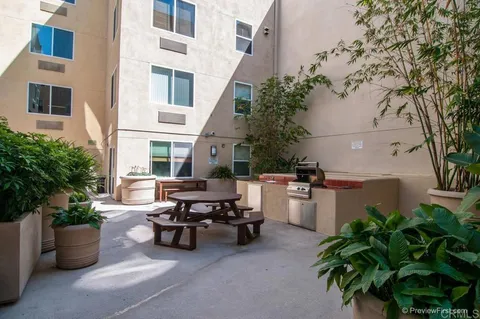 a view of a patio with plants and table and chairs and potted plants