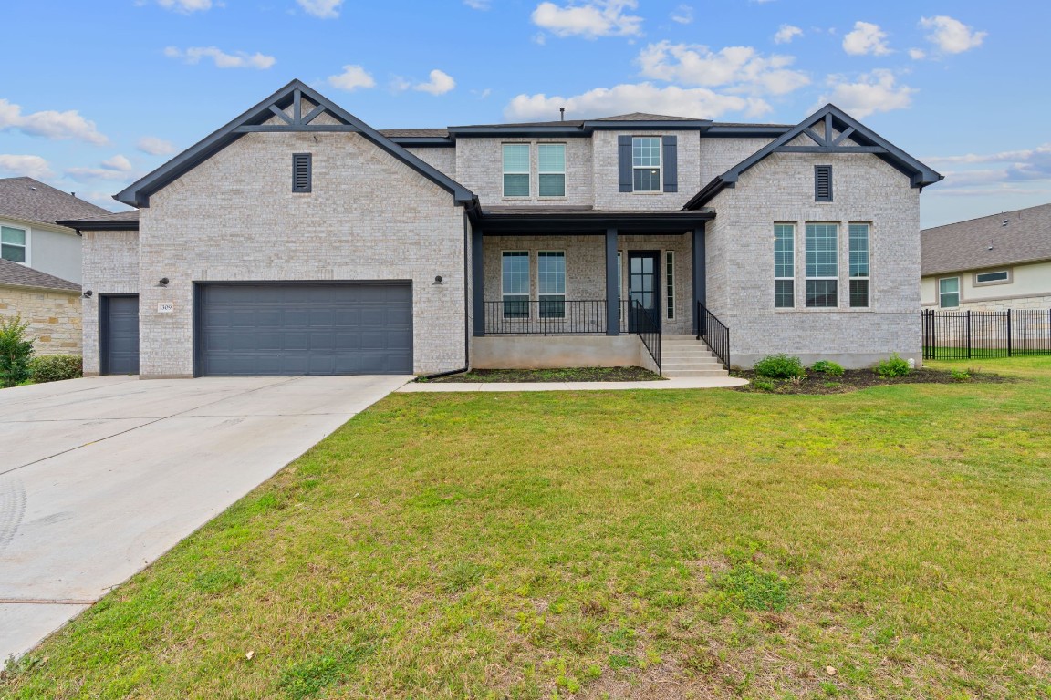a front view of a house with a yard and garage