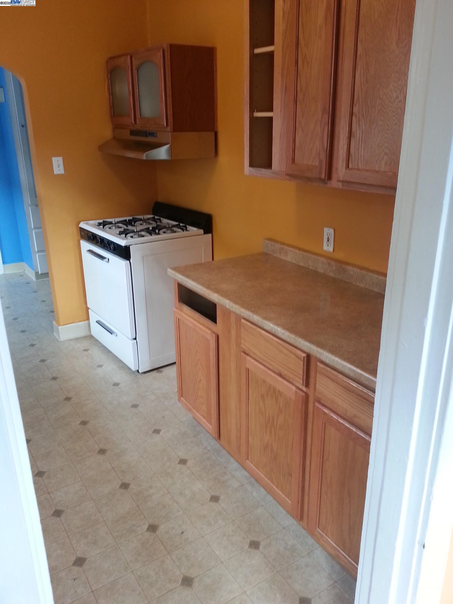 Jefferson Oakland, CA 94601 - Photo 11 of 14 a kitchen with white cabinets and white appliances