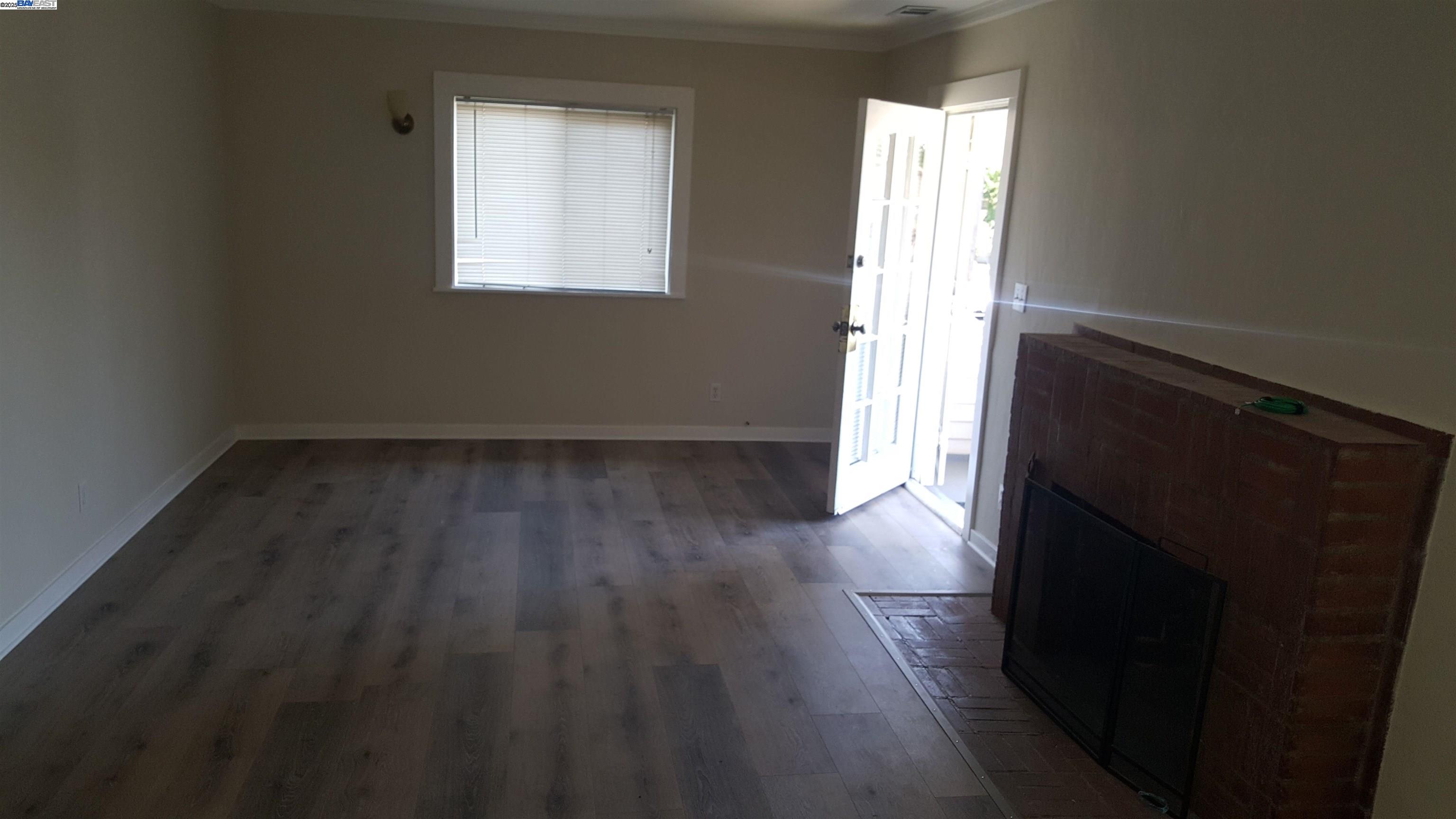 Jefferson Oakland, CA 94601 - Photo 7 of 14 an empty room with wooden floor and windows