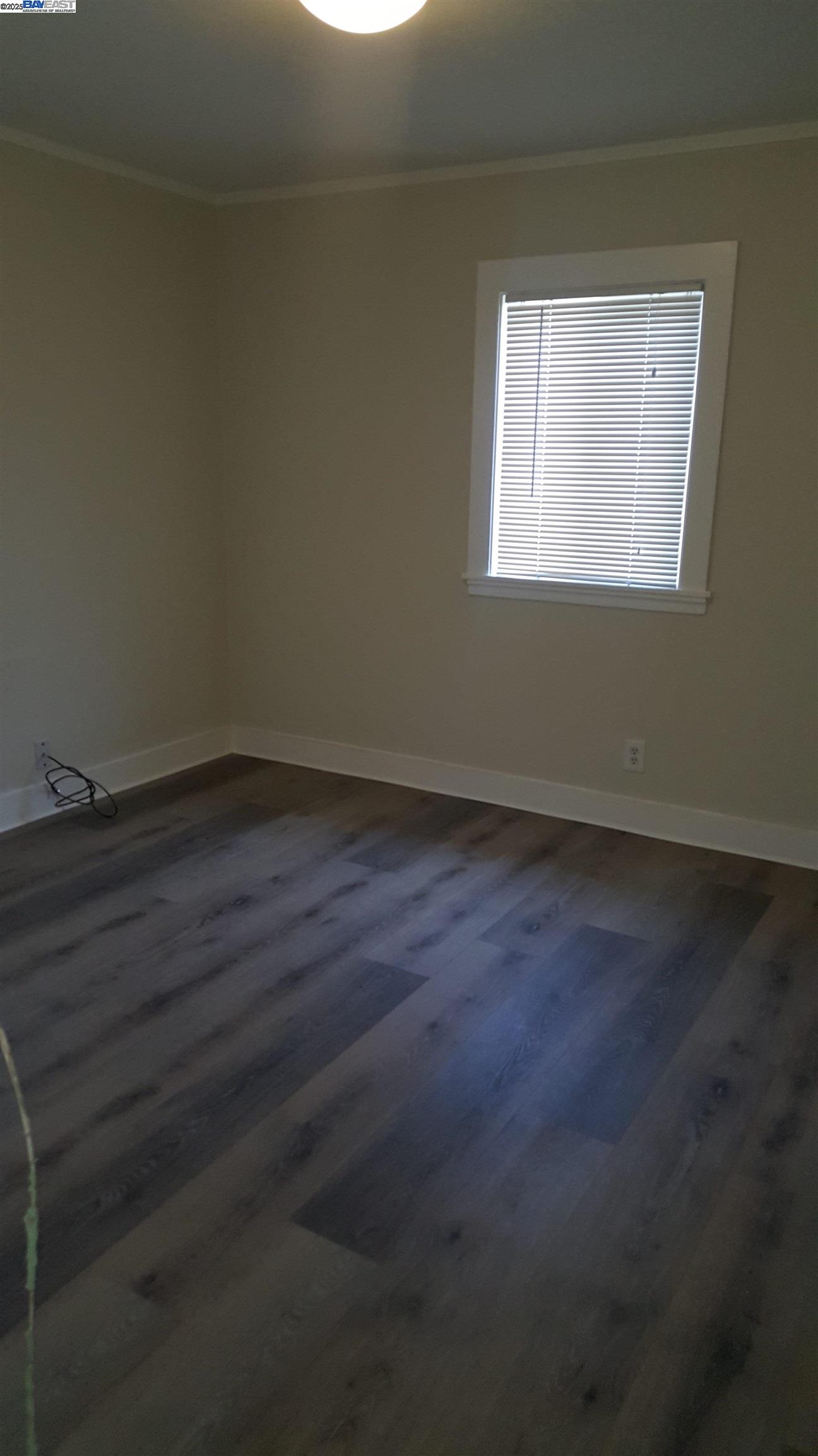 Jefferson Oakland, CA 94601 - Photo 9 of 14 an empty room with wooden floor and windows