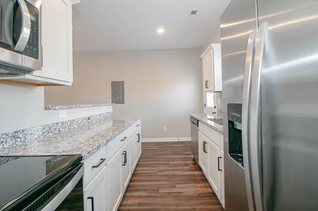 a kitchen with a sink and refrigerator