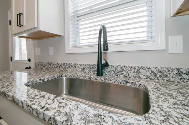a view of a kitchen sink bathtub and window
