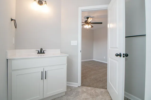 a bathroom with a shower vanity and a sink