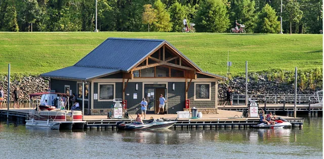 a view of a house with a yard from a lake view