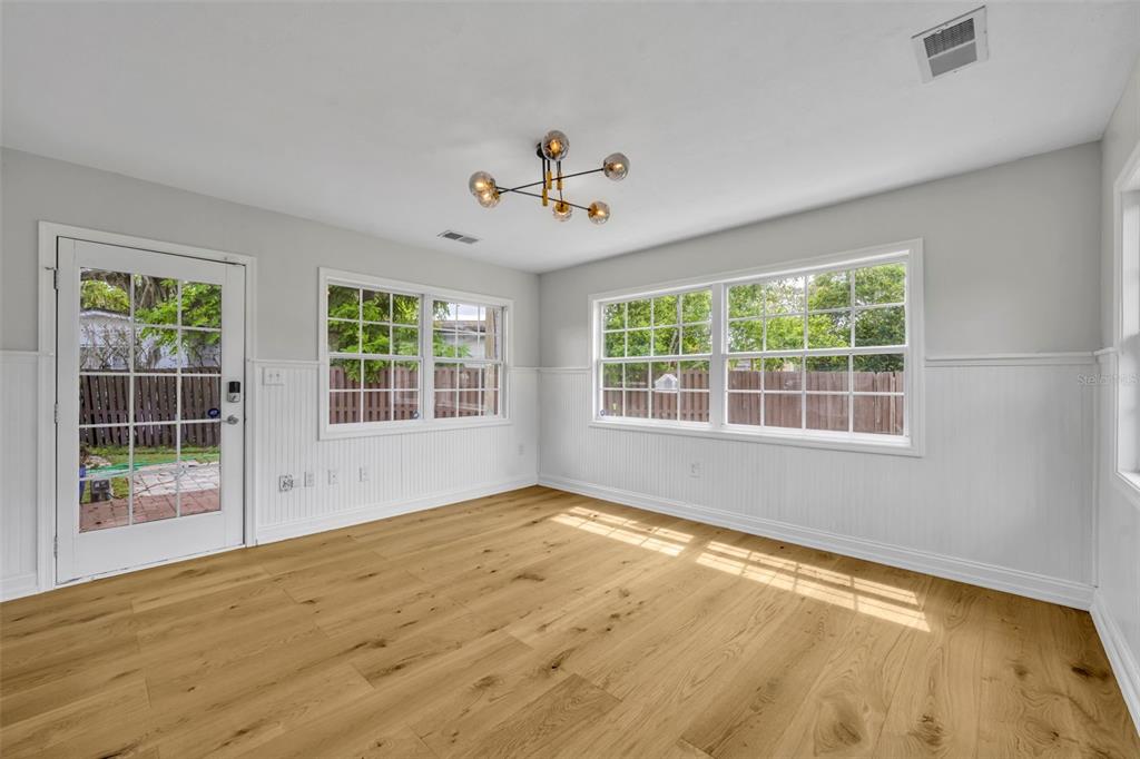 4234 Kendrick Road Orlando, FL 32804 - Photo 20 of 46 a view of an empty room with wooden floor and a window