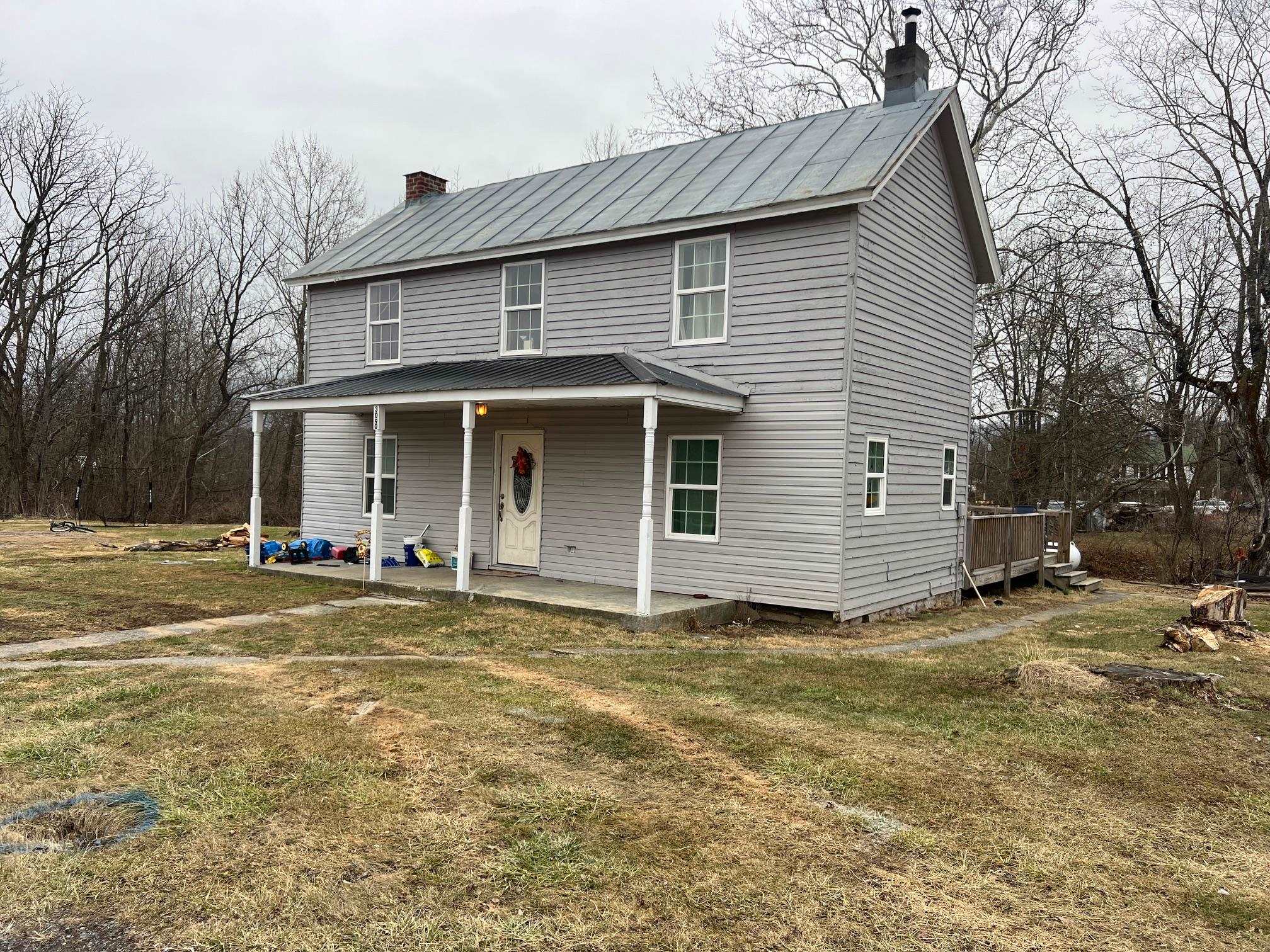 a view of a house with a yard and garage