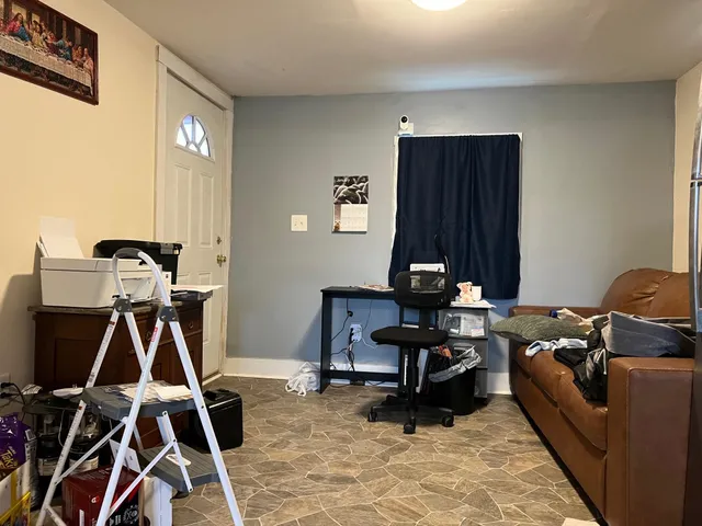 a work room with furniture and musical instruments