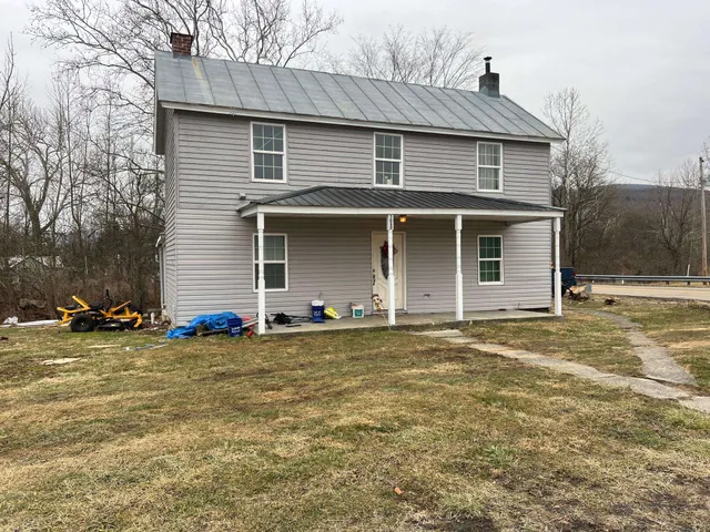 a view of a house with a yard and garage