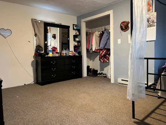 a bed room with a bed and a mirror